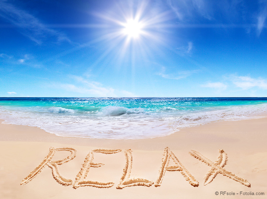 word "relax" on the tropical beach